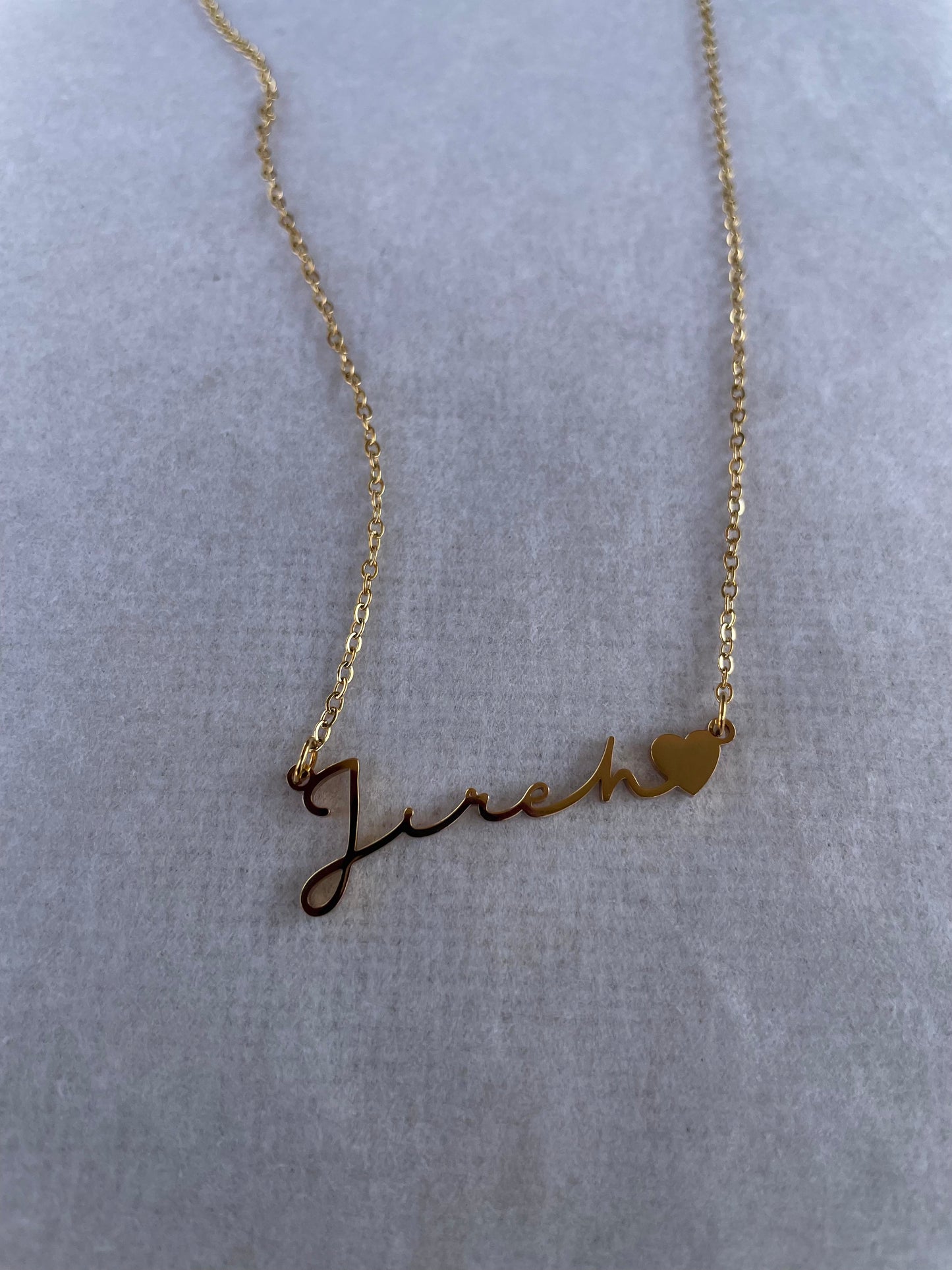 Jireh - God will provide. God the provider necklace on a flat white surface.