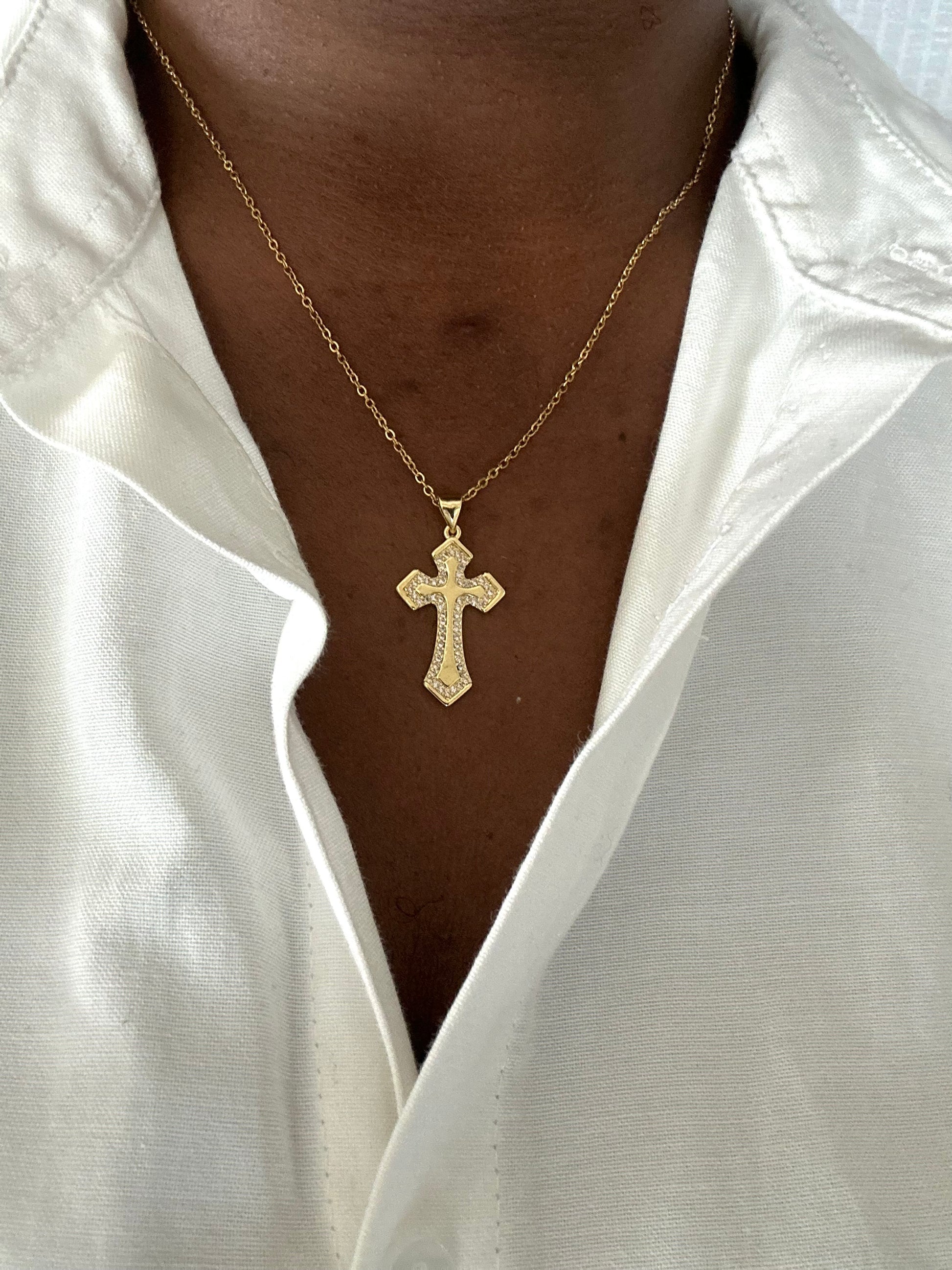 Truth Cross Necklace styled by the model in a white T-shirt showing it's full length.