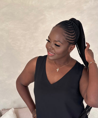 The model as seen in her braids is also wearing the pearl cross bracelet and the aga love bracelet