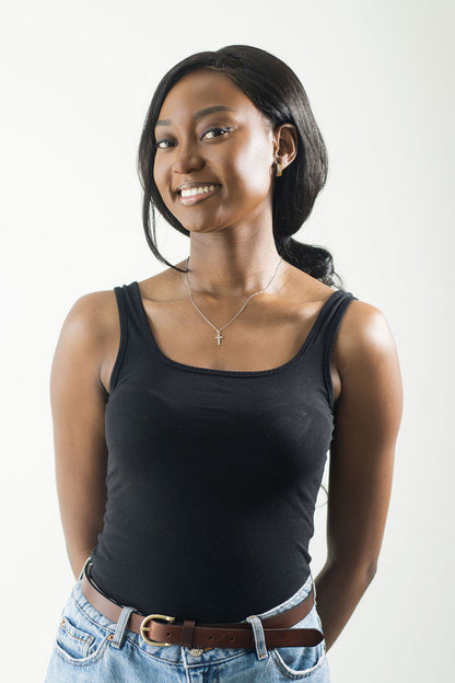 full picture of mode smiling in a black tank top and wearing the mini cross necklace