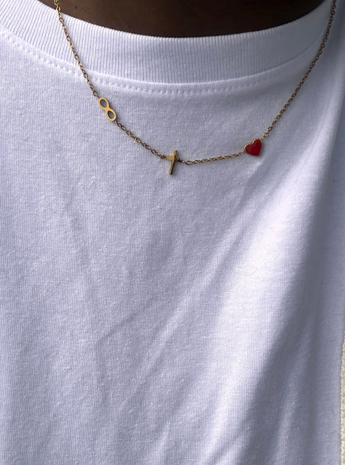 eternity pendant, cross and red heart john 3:16 necklace being worn with a white crew neck shirt