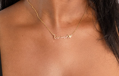 Close-up detail of Loved necklace showing elegant script lettering and gold finish